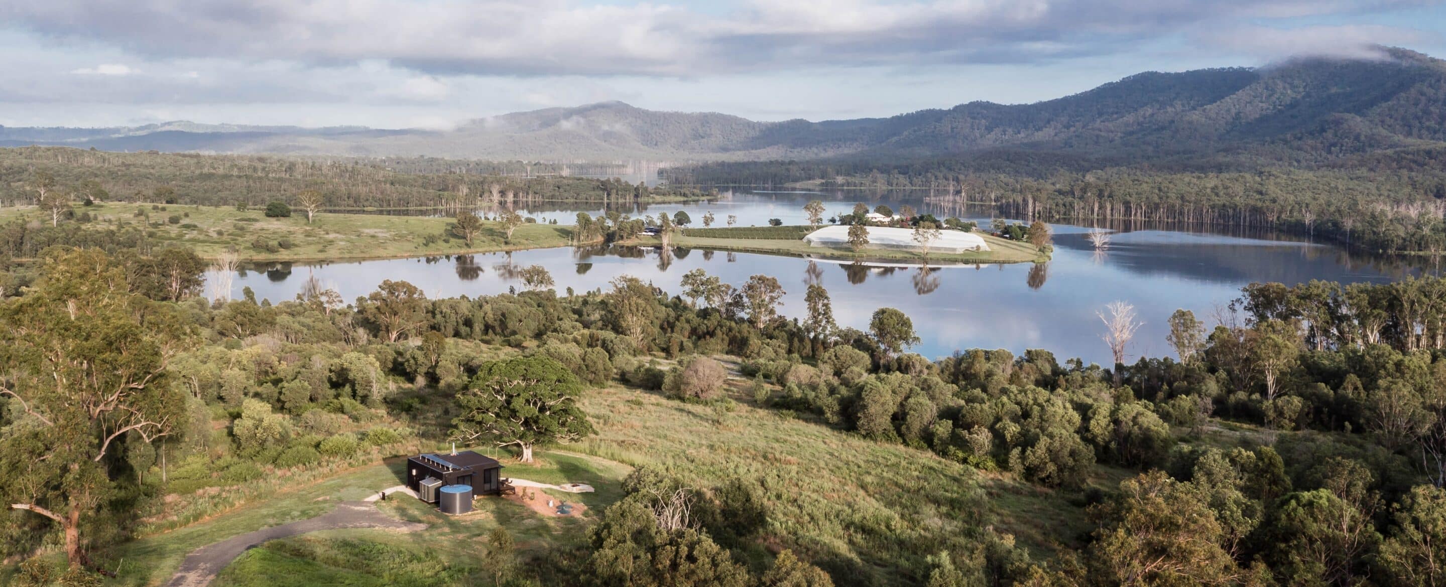 Aerial view of Crumpet WanderPod overlooking Lake Wyaralong, Scenic Rim